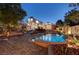 Stunning backyard oasis featuring a pristine pool with waterfall and desert landscaping at 8470 S Pioneer Way, Las Vegas, NV 89113