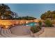 Backyard pool with surrounding brick patio, landscaping, and decorative accent lighting, creating a peaceful retreat at 8470 S Pioneer Way, Las Vegas, NV 89113