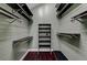 Bright walk-in closet with an abundance of shelving and dark wood flooring at 8470 S Pioneer Way, Las Vegas, NV 89113