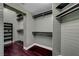 Spacious walk-in closet featuring rod and shelf storage and dark wood flooring at 8470 S Pioneer Way, Las Vegas, NV 89113