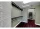 Open walk-in closet with dark wood flooring and modern shelving units at 8470 S Pioneer Way, Las Vegas, NV 89113