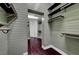 Walk-in closet with plenty of hanging and shelving storage and dark wood flooring at 8470 S Pioneer Way, Las Vegas, NV 89113