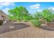 Private backyard featuring desert landscaping and mature trees offering ample shade at 8620 Prairie Hill Dr, Las Vegas, NV 89134