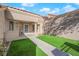 Inviting home entryway with a sidewalk leading to the front door and small patch of grass at 8620 Prairie Hill Dr, Las Vegas, NV 89134