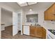 Functional kitchen with white countertops, wood cabinets, and modern appliances, including a dishwasher at 8620 Prairie Hill Dr, Las Vegas, NV 89134
