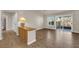 Spacious living room with wood-look flooring, natural light, and sliding glass door to the backyard at 8620 Prairie Hill Dr, Las Vegas, NV 89134