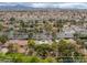 Aerial view of a home in a tree-lined neighborhood with a sparkling pool at 9 Quail Run Rd, Henderson, NV 89014