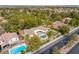 Overhead view of the home and neighborhood, featuring a sparkling pool and manicured landscaping at 9 Quail Run Rd, Henderson, NV 89014