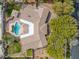 Bird's eye view of the house featuring a backyard oasis with a pool, patio, and lush landscaping at 9 Quail Run Rd, Henderson, NV 89014