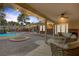 A relaxing backyard features a pool, a fire pit, brickwork and seating under a covered patio at 9 Quail Run Rd, Henderson, NV 89014