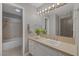Bathroom with a tiled countertop, single sink vanity, and bathtub with shower at 9 Quail Run Rd, Henderson, NV 89014