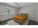 Bedroom with dark wood floors, gray walls, large window with shutters, and a bed with a gray frame and gold comforter at 9 Quail Run Rd, Henderson, NV 89014