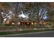 Charming single-story brick home with a lush green lawn and mature shade trees at 9 Quail Run Rd, Henderson, NV 89014