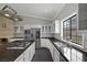 Modern kitchen features stainless steel appliances, sleek countertops, white cabinetry, and a large island with a cooktop at 9 Quail Run Rd, Henderson, NV 89014
