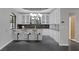 Stylish wet bar featuring white cabinets, granite countertops, and modern lighting at 9 Quail Run Rd, Henderson, NV 89014