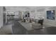 Spacious living room with a decorative stepped floor that leads to a stylish entertaining area, connecting indoor and outdoor spaces at 9 Quail Run Rd, Henderson, NV 89014