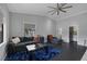 Bright living room featuring a modern ceiling fan and a comfortable gray sectional couch at 9 Quail Run Rd, Henderson, NV 89014