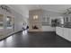 Open-concept living room and kitchen area featuring a stone fireplace and seamless access to a beautiful backyard pool area at 9 Quail Run Rd, Henderson, NV 89014