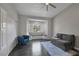 Living room with a window seat, blue accent chair, dark wood flooring, gray walls, and a comfortable gray couch at 9 Quail Run Rd, Henderson, NV 89014