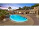 Backyard swimming pool with surrounding patio, landscaped yard, and an outdoor dining area at 9 Quail Run Rd, Henderson, NV 89014