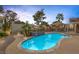 Backyard swimming pool with a built-in water feature, patio, landscaping, and an outdoor structure with seating at 9 Quail Run Rd, Henderson, NV 89014