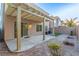 Cozy backyard patio with pergola, brick walkway, and a small landscaped area with synthetic grass at 9006 Cedar Door Ave, Las Vegas, NV 89148