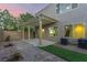 Inviting backyard with a covered patio, artificial turf, brick pavers, and privacy walls at 9006 Cedar Door Ave, Las Vegas, NV 89148