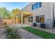 Backyard view showcasing the patio, small lawn, brick-paved area, and stucco exterior of the home at 9006 Cedar Door Ave, Las Vegas, NV 89148
