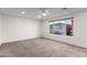 Spacious bedroom with neutral carpet, a ceiling fan and a large window at 9006 Cedar Door Ave, Las Vegas, NV 89148