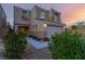 Stylish two-story home with neutral stucco, a two-car garage, and manicured landscaping at 9006 Cedar Door Ave, Las Vegas, NV 89148