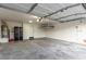 Spacious two car garage with painted walls, concrete flooring, and ample storage space at 9006 Cedar Door Ave, Las Vegas, NV 89148