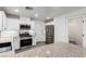 Contemporary kitchen with white cabinets, stainless steel appliances, and granite counters with breakfast bar at 9006 Cedar Door Ave, Las Vegas, NV 89148