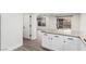 Open-concept kitchen with granite countertops, white cabinets, and wood-look flooring at 9006 Cedar Door Ave, Las Vegas, NV 89148