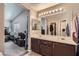 Bright bathroom featuring double sink vanity, a large mirror, and ample storage at 9465 Milkweed Canyon Ave, Las Vegas, NV 89166