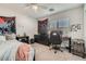 Bright bedroom with a ceiling fan, dresser, desk, and coordinated decor at 9465 Milkweed Canyon Ave, Las Vegas, NV 89166