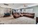 Open-concept living space featuring a sectional sofa, dining area, and modern kitchen at 9465 Milkweed Canyon Ave, Las Vegas, NV 89166