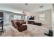 Spacious living room with a large sectional sofa, TV, and ample natural light at 9465 Milkweed Canyon Ave, Las Vegas, NV 89166