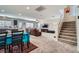 Open floor plan combining dining and living areas, with stairs leading up to the next level at 9465 Milkweed Canyon Ave, Las Vegas, NV 89166
