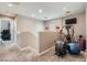 Versatile loft space with exercise equipment, a television, and natural light at 9465 Milkweed Canyon Ave, Las Vegas, NV 89166