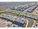 Panoramic aerial view highlighting a gray home with solar panels near desert landscaping and highway at 9608 Bloodstone Ln, Las Vegas, NV 89143