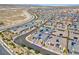 Expansive community aerial view showcasing a gray home with solar panels, landscaping, and proximity to highways at 9608 Bloodstone Ln, Las Vegas, NV 89143