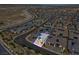 Scenic aerial shot capturing a gray home with solar panels in a desert community near highways at 9608 Bloodstone Ln, Las Vegas, NV 89143