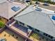 Aerial view capturing a gray tiled roof, brick patio, solar panels, and desert landscape in the backyard at 9608 Bloodstone Ln, Las Vegas, NV 89143