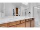 Bright bathroom featuring a double sink vanity with modern fixtures and a large mirror at 9608 Bloodstone Ln, Las Vegas, NV 89143