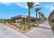 A well-maintained building with palm trees and landscaping along a sidewalk at 9608 Bloodstone Ln, Las Vegas, NV 89143