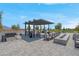 Inviting outdoor lounge area with modern furniture, fire pit, and oversized chess set at 9608 Bloodstone Ln, Las Vegas, NV 89143