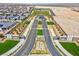Aerial view of an impressive community entrance with a gated entry, manicured landscaping, and well-maintained roads at 9608 Bloodstone Ln, Las Vegas, NV 89143
