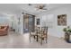 Bright dining area features a glass table, neutral decor, and sliding glass door access to the outdoor space at 9608 Bloodstone Ln, Las Vegas, NV 89143