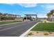 Elegant community entrance with manicured landscaping and an American flag at 9608 Bloodstone Ln, Las Vegas, NV 89143