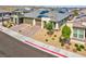 Beautiful single-story home featuring a desert landscape, solar panels, brick driveway, and a two-car garage at 9608 Bloodstone Ln, Las Vegas, NV 89143